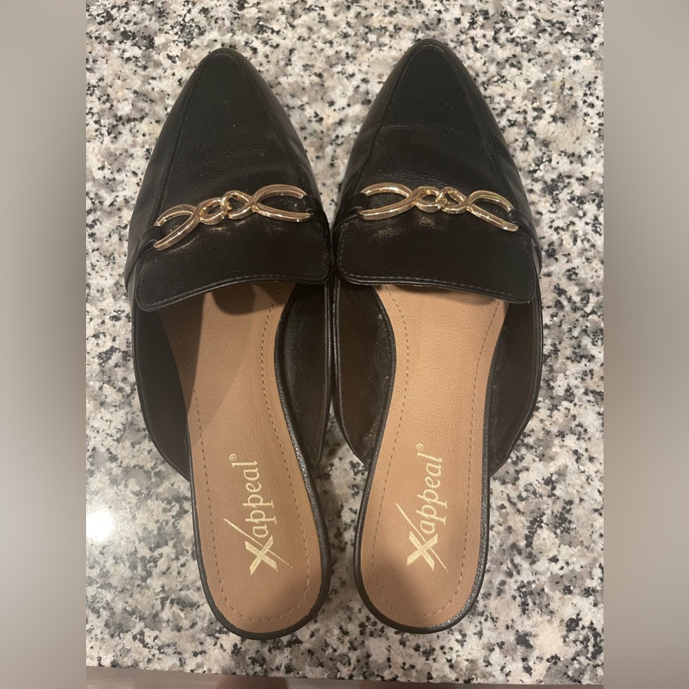 Black mules with gold buckle